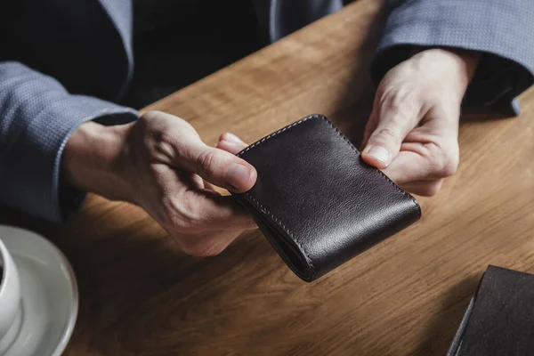 Business man at the table with a wallet Royalty Free Stock Images