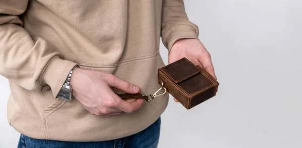Man holds in his hand a cigarette case made of brown craft leather Royalty Free Stock Photos