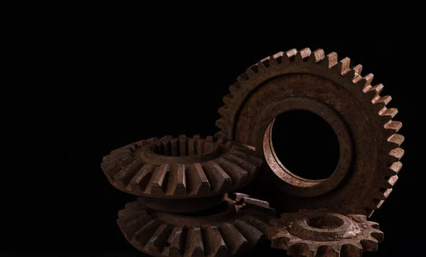 Old rusty metal gears on a black background close-up Royalty Free Stock Photos
