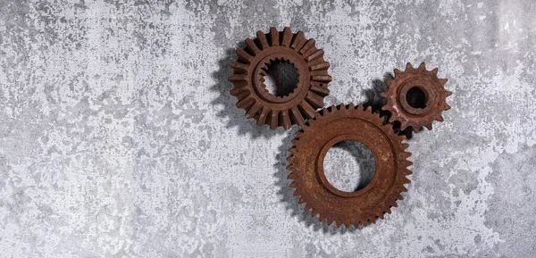 Old rusty metal gears on a gray background Royalty Free Stock Photos