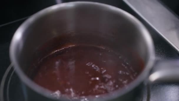 Close-up saucepan with red hot sauce boiling inside. Delicious tasty barbecue chili sauce cooking in restaurant kitchen indoors. — Stock Video