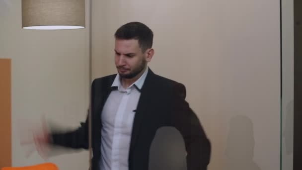 Nervous young handsome businessman throwing away paperwork sighing standing in glass office indoors. Portrait of stressed overburdened Caucasian entrepreneur thinking on failure indoors. — Stock Video