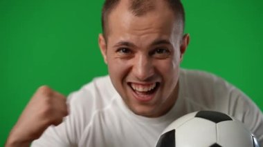 Successful sportsman leaning to camera gesturing yes smiling on green screen. Portrait of satisfied excited Caucasian young man looking at camera posing at chromakey background. Championship.