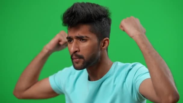 Young worried Middle Eastern football fan cheering for team looking away gesturing on green screen. Handsome anxious man supporting soccer team on championship at chromakey background. — Stock Video