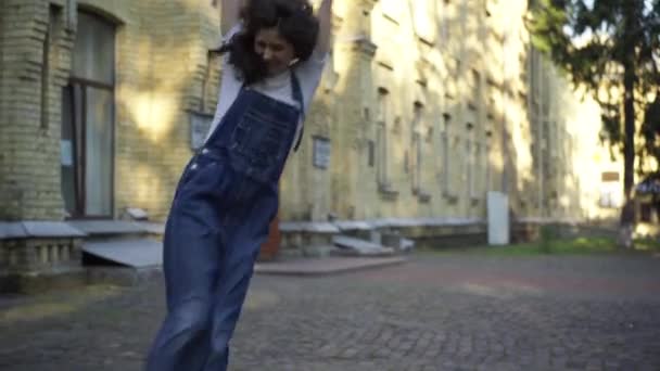 Excited young woman rejoicing jumping walking at university campus leaving. Portrait of happy intelligent Caucasian student having fun on sunny morning outdoors. Achievement and education concept. — ストック動画