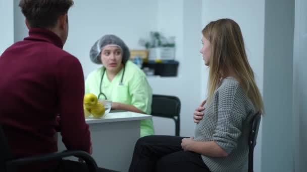 Stressed Pregnant Woman Holding Head Hands Sitting Man Doctor Office — Stock Video