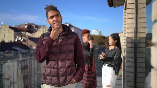 Young Thoughtful Man Looking Away Thinking Blurred Women Chatting Background — Vídeos de Stock