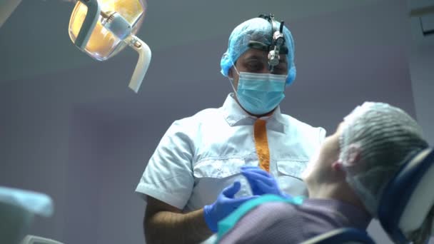 Professional Middle Eastern Dentist Talking Patient Dental Chair Rubbing Gloves — Stock video