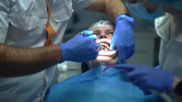 Live Camera Follows Dentist Injecting Anesthesia Patient Dental Chair Turning — Stock video
