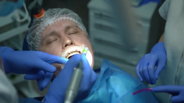 Close Portrait Caucasian Patient Dental Chair Closing Eyes Doctor Drilling — Stockvideo