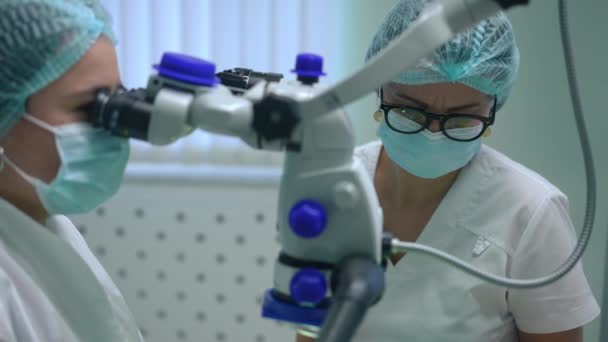 Professional Assistant Adjusting Dental Microscope Blurred Dentist Examining Patient Hospital — Stockvideo