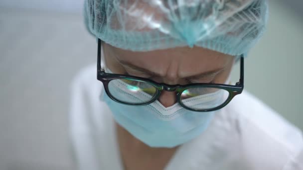 Close Face Focused Dentist Face Mask Eyeglasses Working Indoors Hospital — Stockvideo