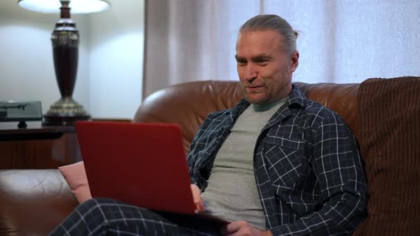 Positive Handsome Man Pajamas Waving Talking Video Chat Laptop Sitting — Stockvideo