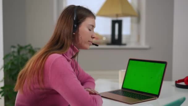 Charming Smart Young Woman Headphones Posing Green Screen Laptop Home — Vídeo de Stock