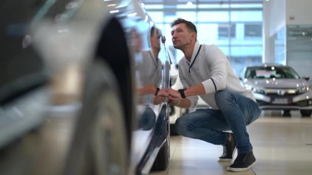 Portrait Confident Man Examining Car Tires Sitting Hunkers New Automobile — Αρχείο Βίντεο