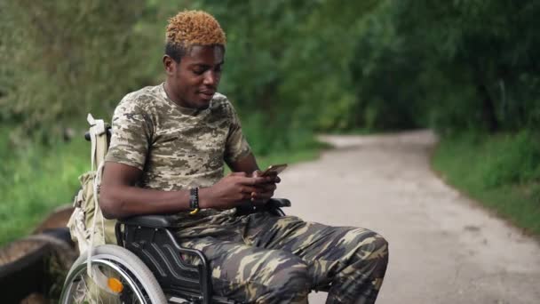 Positive Relaxed African American Man Wheelchair Scrolling Social Media Smartphone — Video