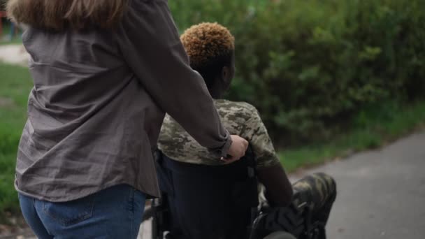 Tracking Shot Young Caucasian Girlfriend Pushing Wheelchair African American Boyfriend — Stock video