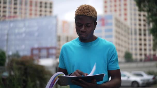 Concentrated Intelligent African American Man Analyzing Paperwork Standing Urban City — Wideo stockowe