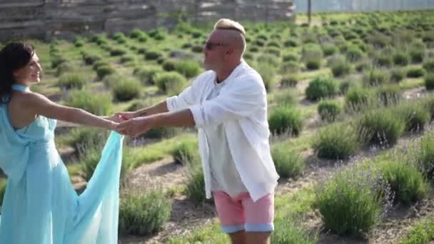 Joyful Adult Couple Spinning Slow Motion Dating Lavender Field Summer — стоковое видео
