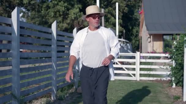 Dolly Shot Portrait Satisfied Confident Farmer Walking Sunshine Outdoors Admiring — стоковое видео