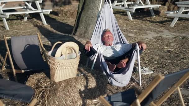 Wide Shot Relaxed Caucasian Man Sunshine Fabric Garden Chair Enjoying — стоковое видео