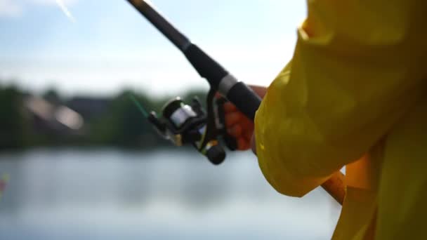 Unrecognizable Fisher Turning Spinning Reel Standing River Bank Summer Morning — Αρχείο Βίντεο