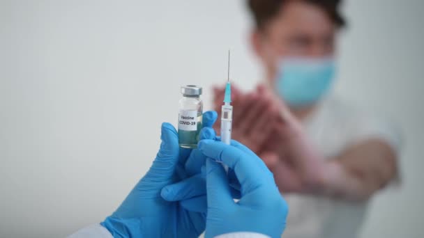 Coronavirus Vaccine Ampoule Syringe Blurred Man Face Mask Refusing Vaccination — ストック動画