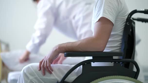 Unrecognizable Man Wheelchair Waiting Nurse Making Bed Background Side View — Video