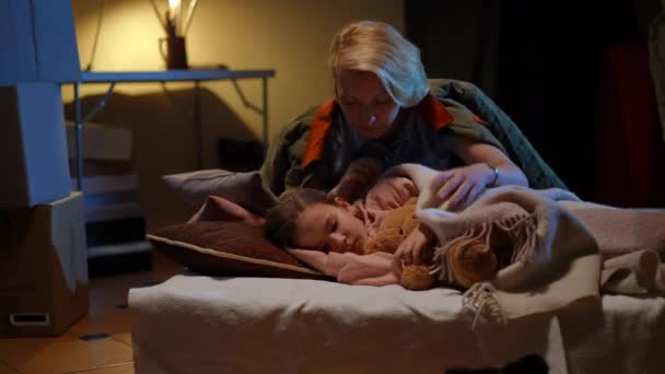 Sad Mother Covering Daughter Sleeping Bomb Shelter Caressing Hair Thinking — Stock videók