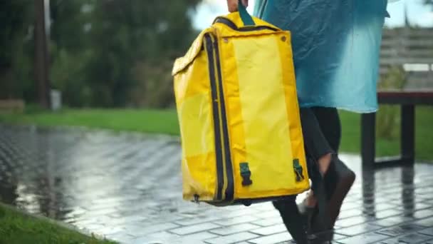 Tracking Shot Yellow Delivery Bag Hand Unrecognizable Courier Rain Coat — Vídeo de Stock