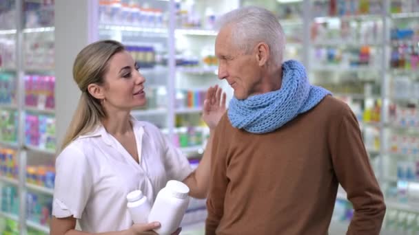 Charming Caucasian Young Woman Touching Shoulder Senior Man Standing Pharmacy — 图库视频影像