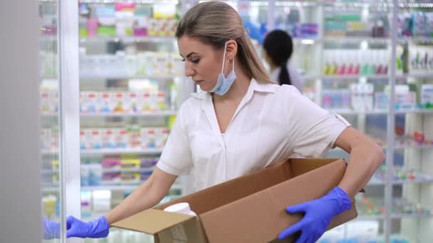Focused Intelligent Caucasian Pharmacist Collecting Expired Drugs Shelves Blurred Asian — 图库视频影像