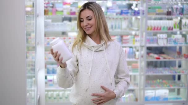 Portrait Happy Pregnant Beautiful Woman Advertising Pills Standing Pharmacy Indoors — Video