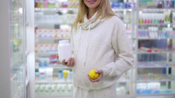 Unrecognizable Smiling Pregnant Woman Juggling Lemon Standing Vitamin Pills Bottle — Wideo stockowe