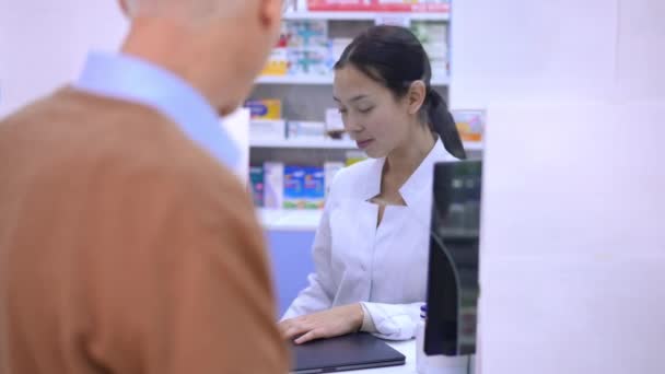 Portrait Asian Woman Passing Shopping Bag Drugs Client Pharmacy Smiling — Video