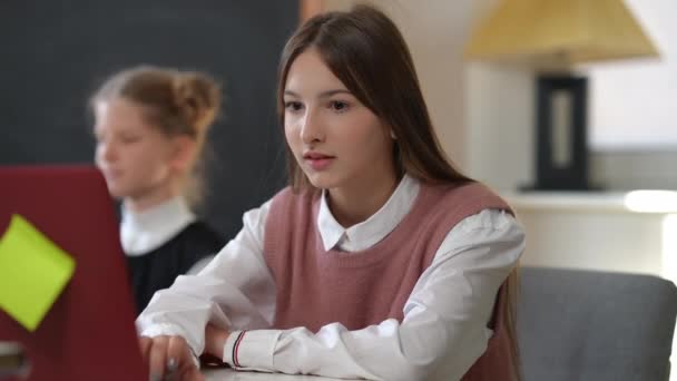 Positive Pretty Schoolgirl Turning Playlist Laptop Putting Headphones Blurred Classmate — ストック動画