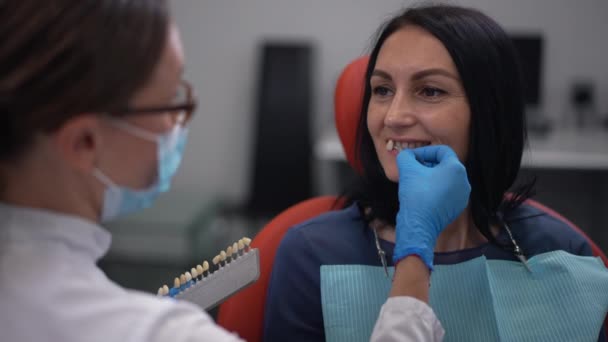 Confident Patient Dental Chair Toothy Smile Professional Dentist Trying Dental — Stockvideo