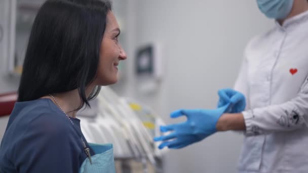 Side View Woman Smiling Looking Dentist Putting Gloves Slow Motion — Stok video