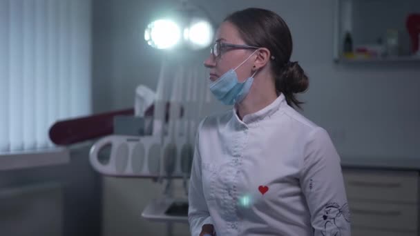 Beautiful Confident Dentist Turning Looking Camera Smiling Dental Light Darkness — Stockvideo