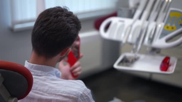 Shooting Shoulder Satisfied Man Admiring Reflection Hand Mirror Sitting Dental — Wideo stockowe