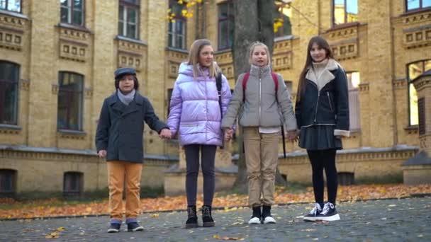 Carefree Cheerful Boy Losing Hat White Jumping Girls Schoolyard Smiling — Stok video