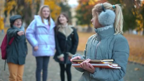 Thoughtful Nerd Teenage Schoolgirl Standing Schoolyard Listening Classmates Sneering Mocking — Stock video