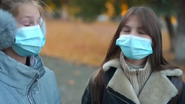 Exhausted Schoolgirls Coronavirus Face Masks Standing Outdoors Talking Dissatisfied Facial — Vídeo de stock