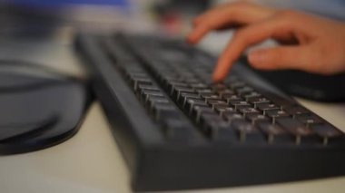 Close-up female hands typing fast on computer keyboard. Unrecognizable slim young Asian woman messaging online surfing Internet in office indoors