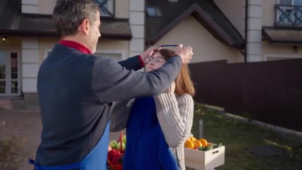 Loving Couple Putting Aprons Standing Front Yard Selling Organic Products — Stock Video
