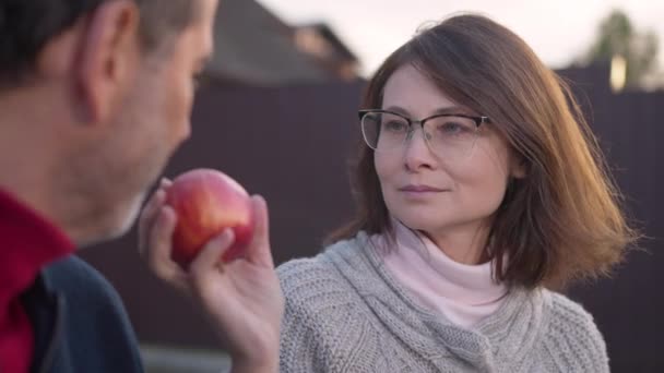 Close Portrait Smiling Beautiful Adult Woman Smelling Red Apple Stretching — Stock Video