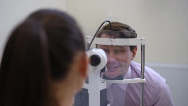 Zoom Smiling Caucasian Man Sitting Slit Lamp Hospital Doctor Examining — Stockvideo