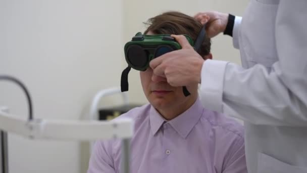 Portrait Caucasian Man Doctor Visit Unrecognizable Ophthalmologist Putting Glasses Color — Vídeo de stock