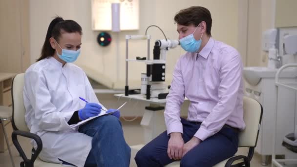 Cheerful Caucasian Doctor Patient Coronavirus Face Masks Talking Smiling Sitting — Stock video