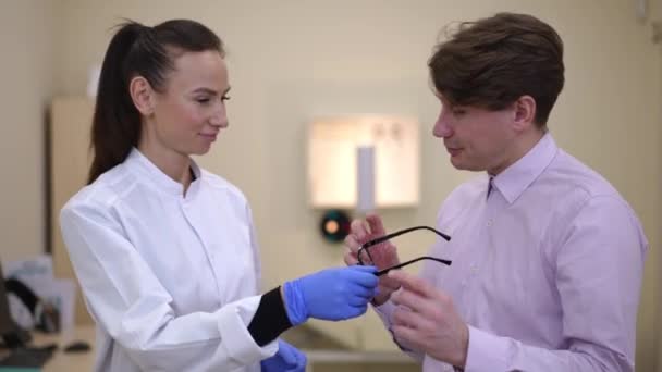 Thankful Caucasian Man Receiving Eyeglasses Doctor Looking Camera Smiling Portrait — 비디오